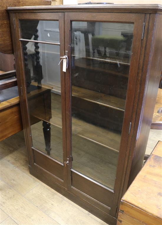 An oak glazed cabinet W.97cm